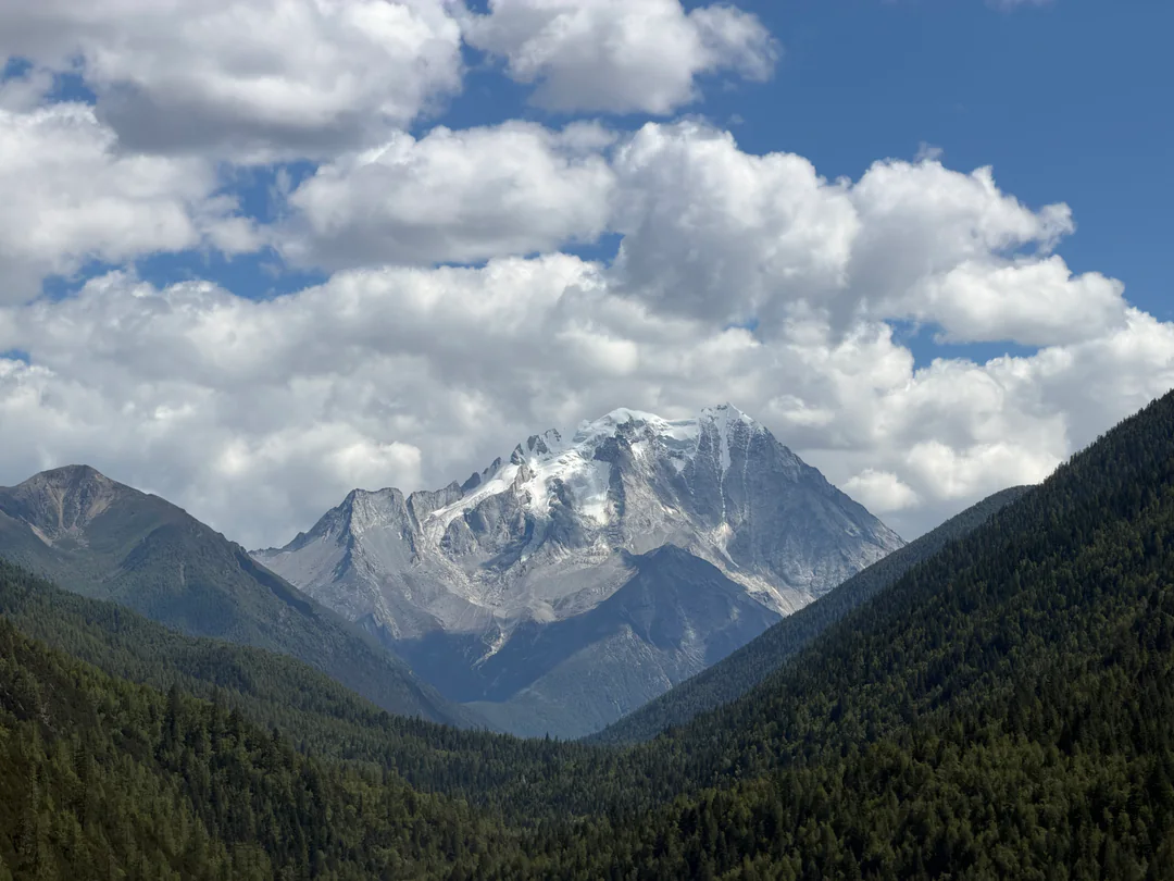 A snow-covered mountain seen along the road