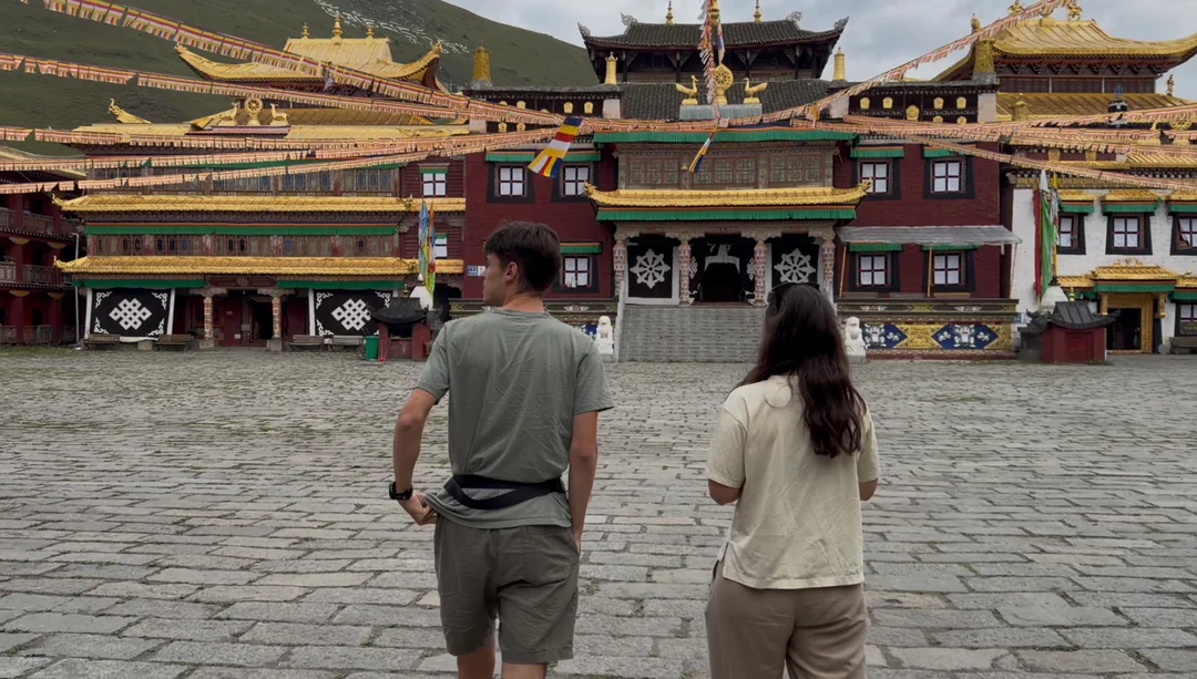 Eva and Martin entering a Muya-style courtyard