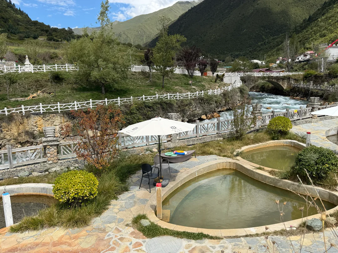 A natural hot spring beside the river in a mountain valley
