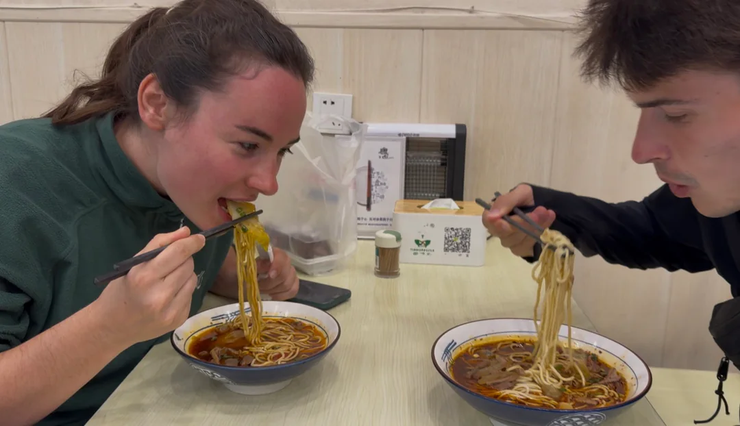 Eva and Martin sharing a meal of noodles