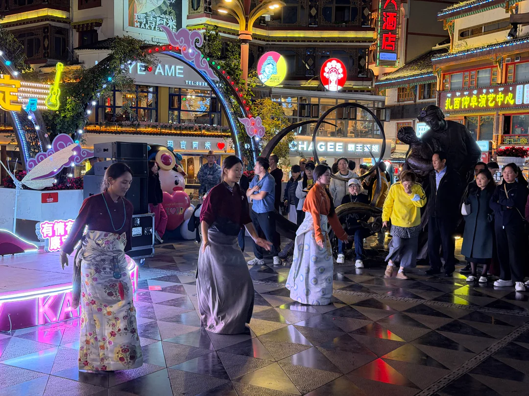 A dancer in traditional dress in Kangding’s evening square