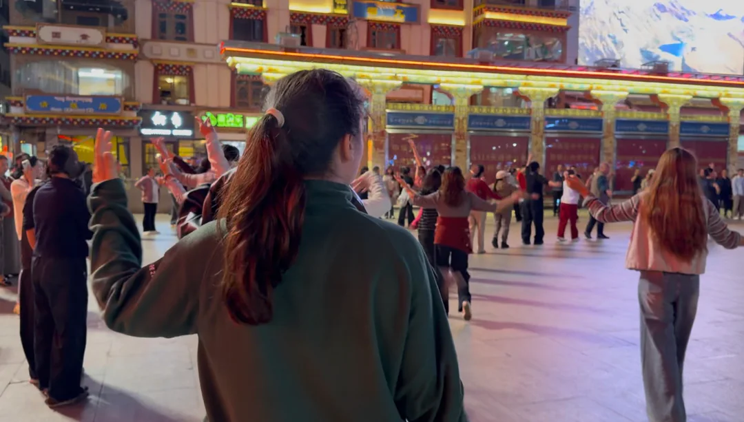 Eva following the dancers in Kangding